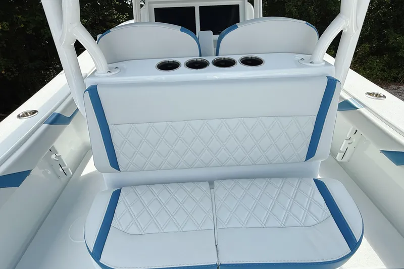 Slide: The Image of 2024 Yellowfin 36 Offshore boat seating with blue accents and cup holders. - 14