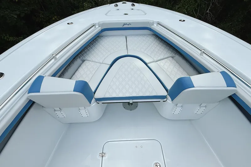 Slide: The Image of 2024 Yellowfin 36 Offshore boat interior with white and blue cushioned seating. - 15