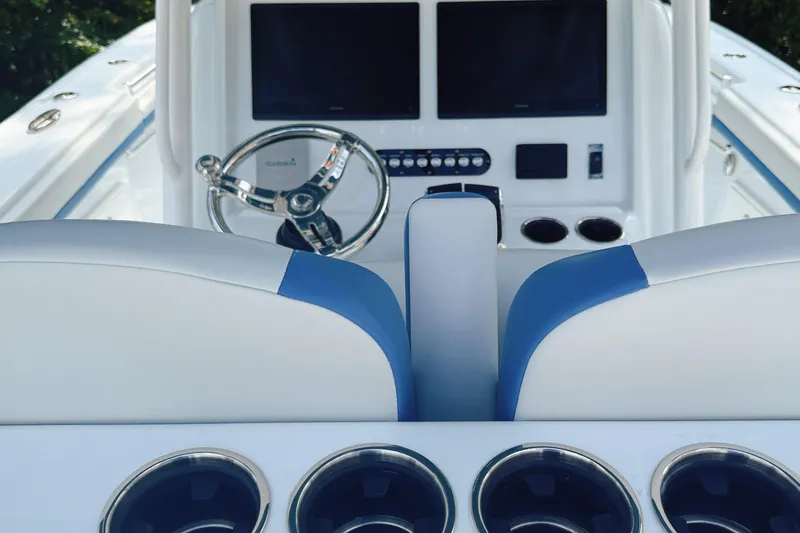 Slide: The Image of 2024 Yellowfin 36 Offshore boat interior with steering wheel and control panel. - 18