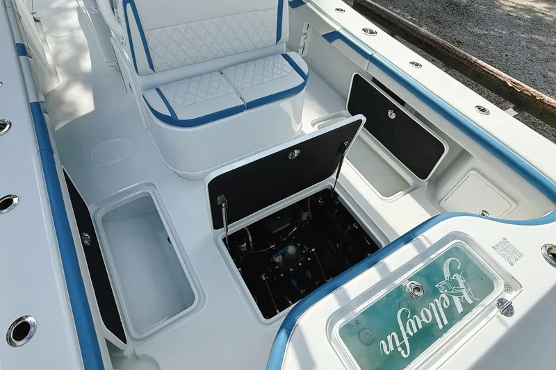Slide: The Image of 2024 Yellowfin 36 Offshore boat interior with open storage compartments and seating. - 19