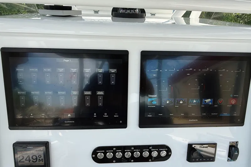 Slide: The Image of 2024 Yellowfin 36 Offshore boat dashboard with dual Garmin displays and control panel. - 22