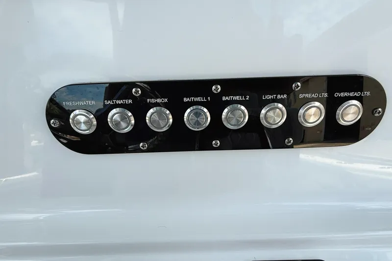 Slide: The Image of Control panel on 2024 Yellowfin 36 Offshore boat with labeled buttons. - 24