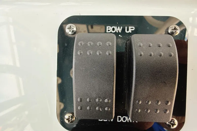 Slide: The Image of 2024 Yellowfin 36 Offshore boat control panel with "Bow Up" and "Bow Down" switches. - 27