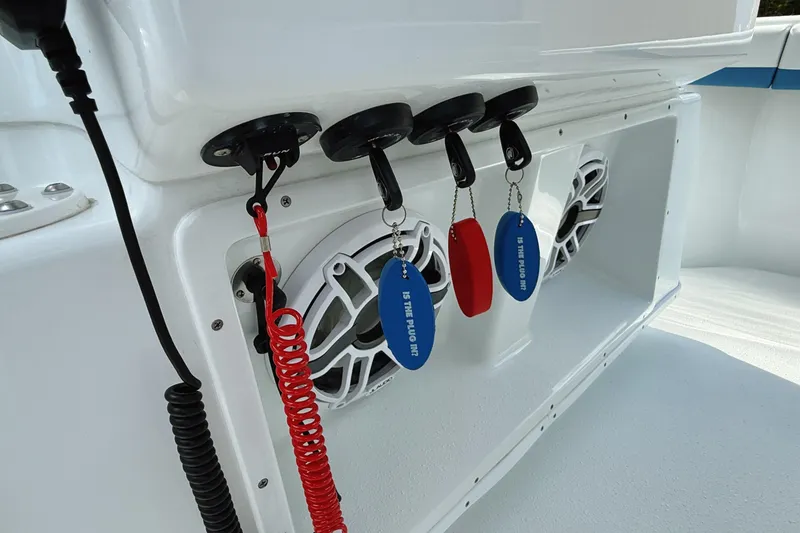 Slide: The Image of 2024 Yellowfin 36 Offshore boat interior with keychains and speakers. - 28