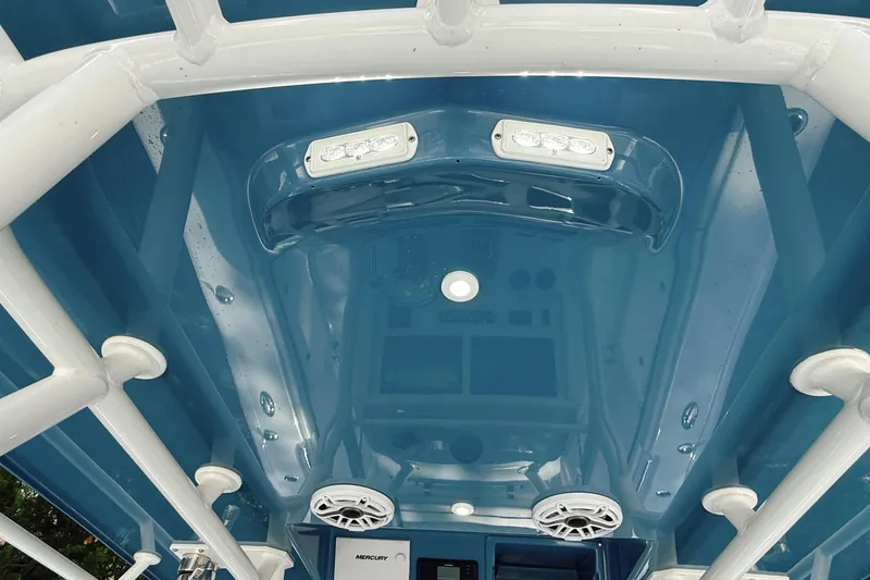 Slide: The Image of 2024 Yellowfin 36 Offshore boat interior with blue ceiling and white framework. - 32