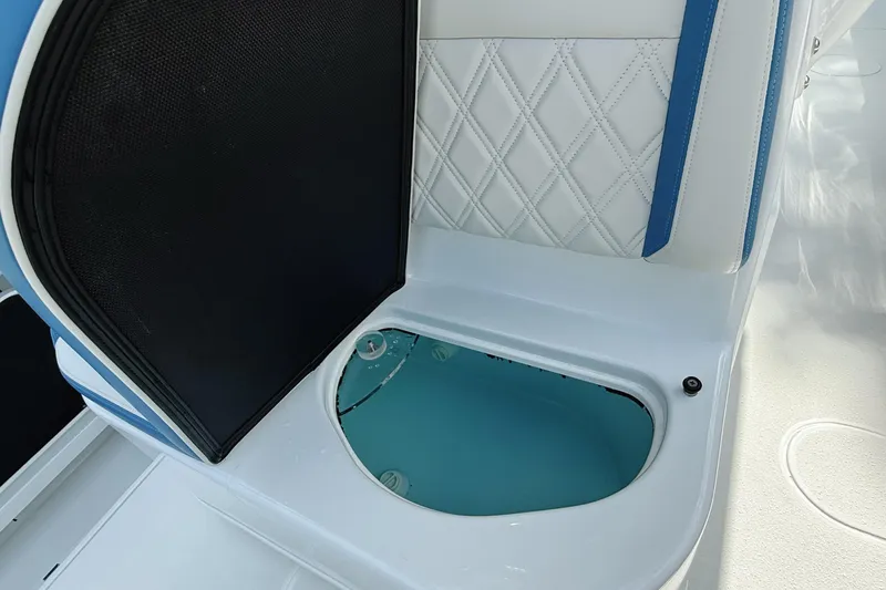 Slide: The Image of 2024 Yellowfin 36 Offshore boat interior with open storage compartment and cushioned seating. - 38