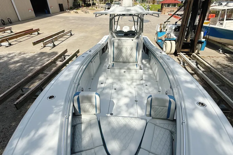 Slide: The Image of 2024 Yellowfin 36 Offshore boat with spacious deck and seating, docked at a marina. - 5