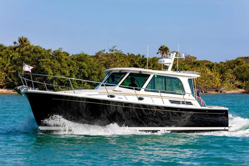 The Image of 2026 Back Cove 372 cruising on calm waters, showcasing sleek design and performance. - 0
