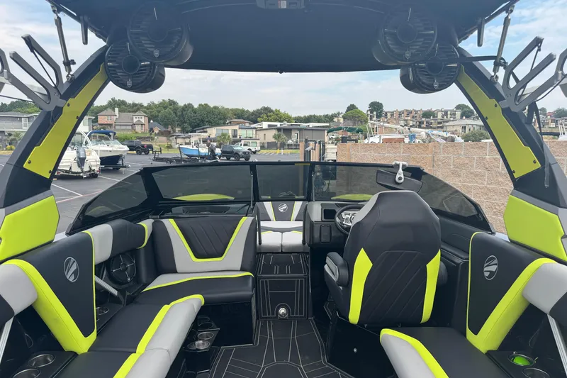 Slide: The Image of 2020 Tigé 23RZX boat interior with sleek black and neon yellow seating. - 12