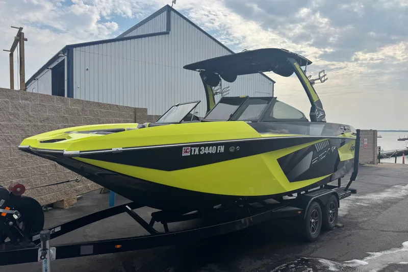 Slide: The Image of 2020 Tigé 23RZX boat interior with modern black and lime green seating design. - 5