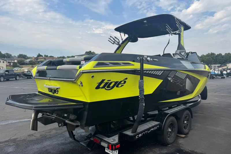 Slide: The Image of 2020 Tigé 23RZX boat interior with modern black, gray, and neon green seating. - 7