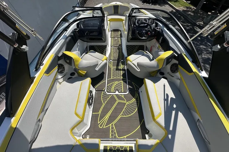 Slide: The Image of 2023 Scarab 215 ID boat interior with modern seating and stylish yellow accents. - 10