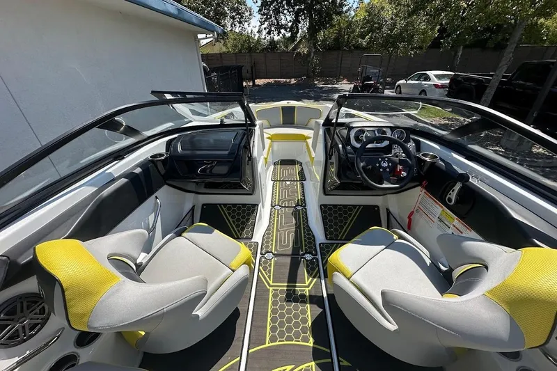 Slide: The Image of 2023 Scarab 215 ID boat interior with yellow and gray seating, modern dashboard, and steering wheel. - 11