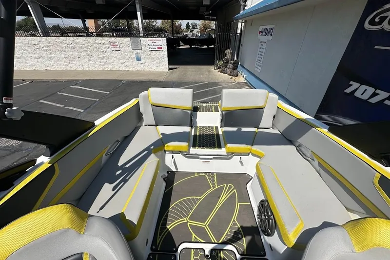 Slide: The Image of 2023 Scarab 215 ID boat interior with yellow accents and modern seating design. - 13