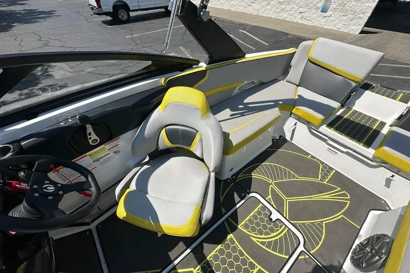 Slide: The Image of 2023 Scarab 215 ID boat interior with yellow and gray seating and modern design. - 14