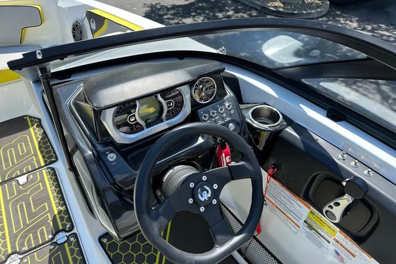Slide: The Image of 2023 Scarab 215 ID boat dashboard with steering wheel and control panel. - 15