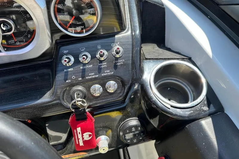 Slide: The Image of Control panel of a 2023 Scarab 215 ID boat with gauges and switches. - 17