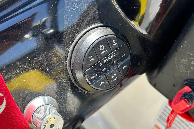 Slide: The Image of Control panel of 2023 Scarab 215 ID boat featuring JL Audio system. - 18