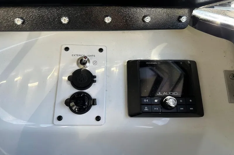 Slide: The Image of Control panel of 2023 Scarab 215 ID boat with JL Audio system. - 21