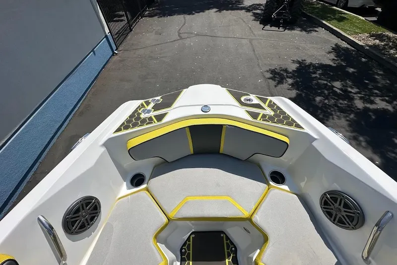 Slide: The Image of 2023 Scarab 215 ID boat interior with yellow accents and speaker system. - 24