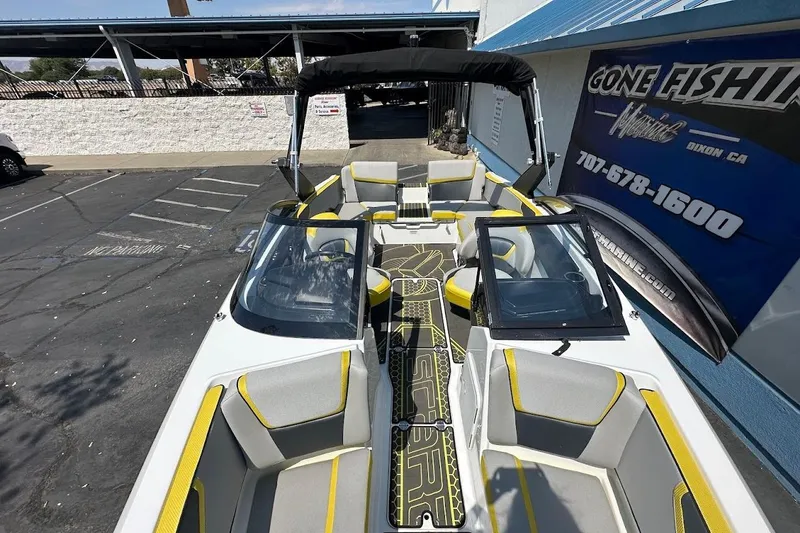 Slide: The Image of 2023 Scarab 215 ID boat with sleek design, yellow accents, and comfortable seating. - 25