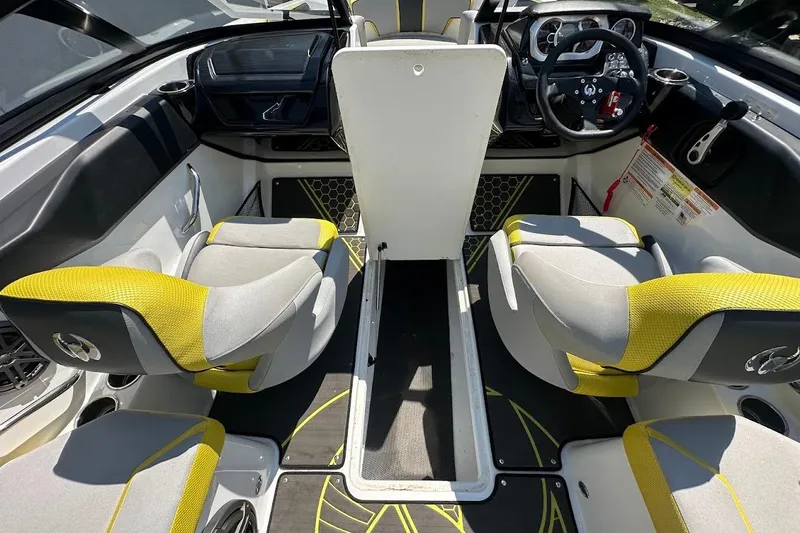 Slide: The Image of 2023 Scarab 215 ID boat interior with modern dashboard and yellow-accented seating. - 31