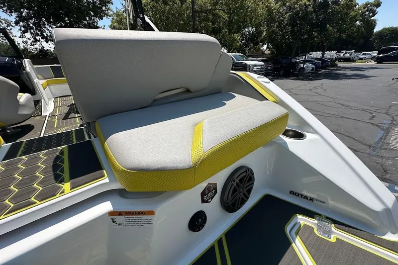 Slide: The Image of 2023 Scarab 215 ID boat interior with gray and yellow seating, featuring Rotax engine. - 33