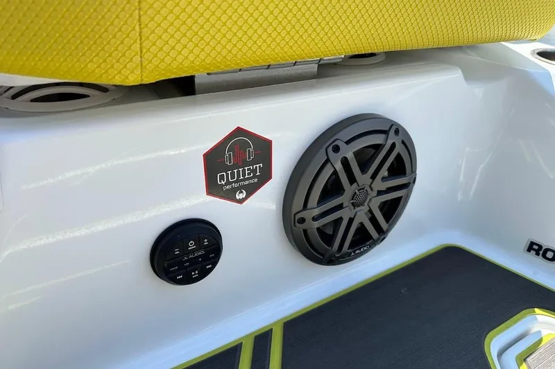 Slide: The Image of 2023 Scarab 215 ID boat interior with speaker and "Quiet Performance" sticker. - 34