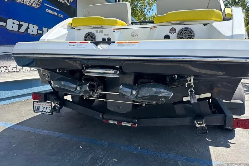 Slide: The Image of Rear view of 2023 Scarab 215 ID boat on trailer, showcasing dual exhausts and speakers. - 35