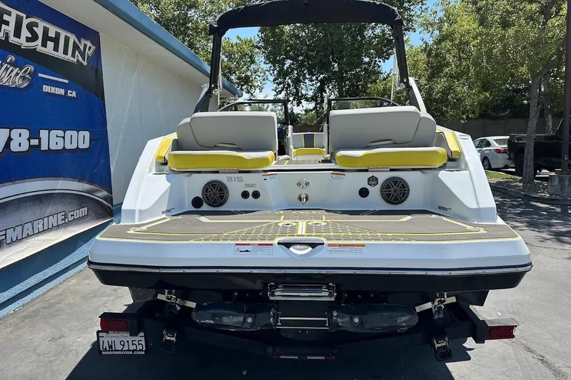 Slide: The Image of 2023 Scarab 215 ID boat, rear view, featuring yellow accents and dual seating. - 7