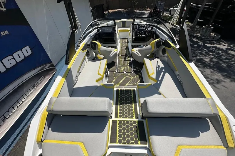Slide: The Image of 2023 Scarab 215 ID boat interior with gray and yellow seating, modern design. - 9