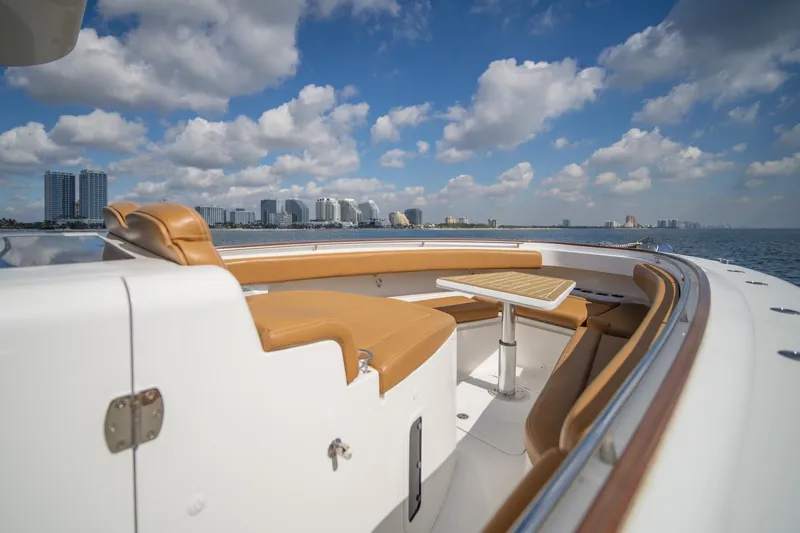 Slide: The Image of 2020 HCB 42 Lujo yacht with tan seating, ocean view, and city skyline. - 15