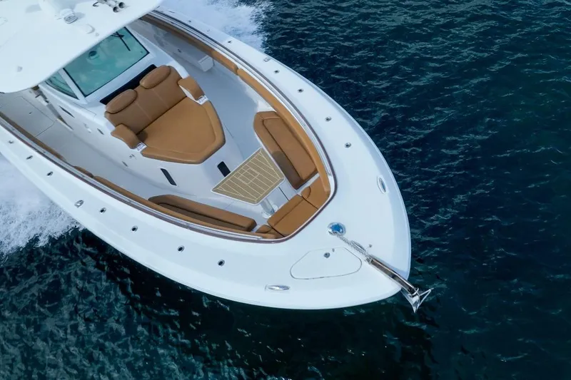 Slide: The Image of 2020 HCB 42 Lujo boat cruising on clear blue water. - 7