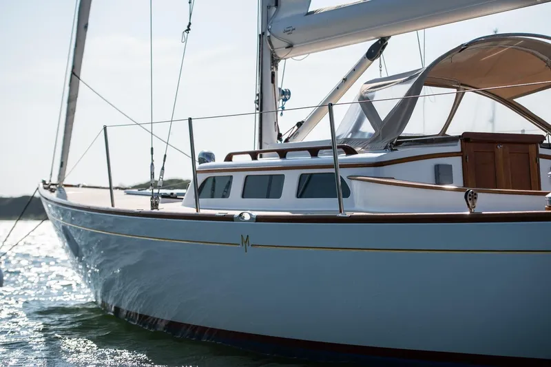 Slide: The Image of 2006 Morris M36 Daysailer on water, elegant design, wooden accents, and sleek lines. - 14