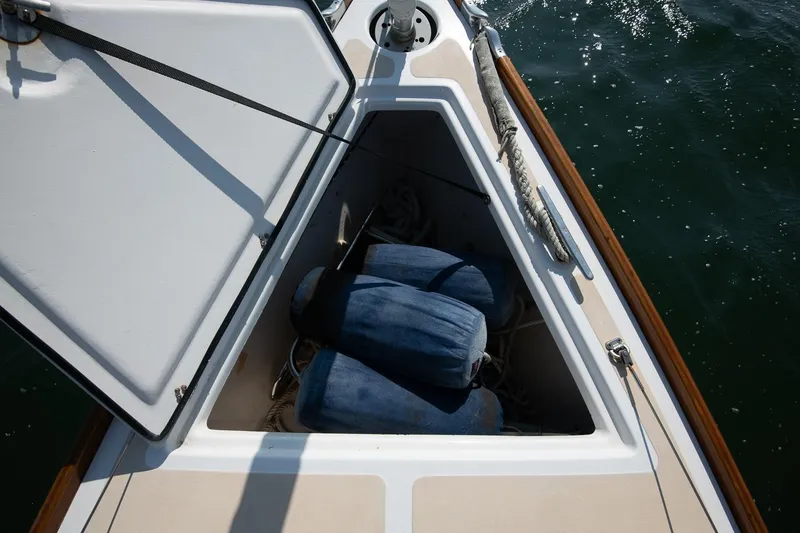Slide: The Image of Open storage compartment on 2006 Morris M36 Daysailer with blue fenders and ropes. - 21