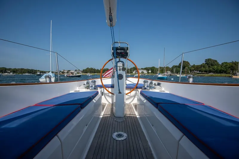 Slide: The Image of 2006 Morris M36 Daysailer with blue seating, docked in a scenic harbor. - 22
