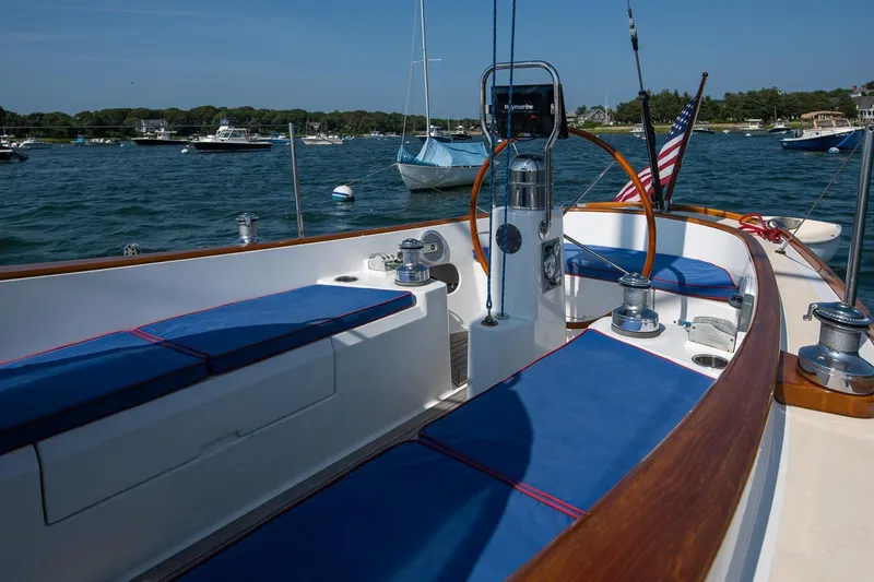 Slide: The Image of 2006 Morris M36 Daysailer with blue seating, docked in a scenic harbor. - 23