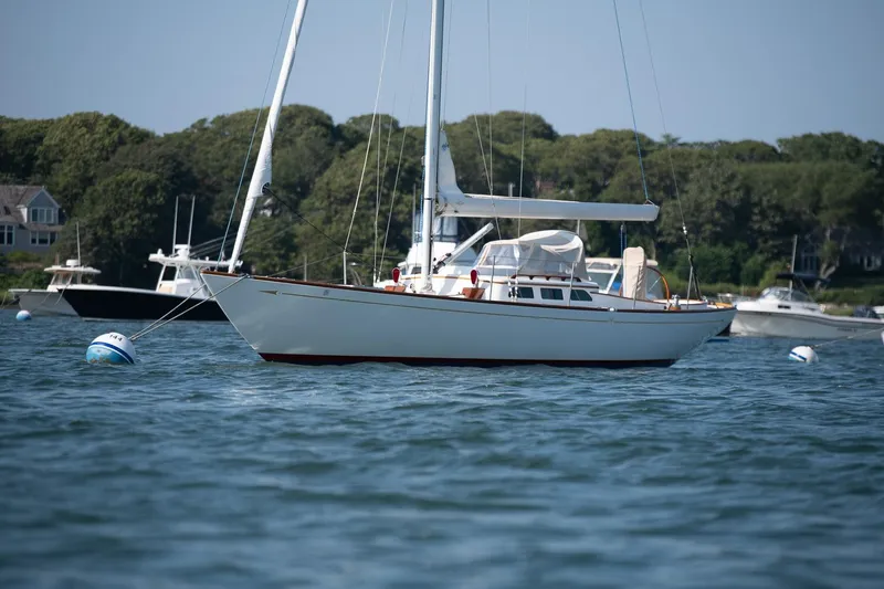 Slide: The Image of 2006 Morris M36 Daysailer anchored in a scenic bay with other boats. - 3