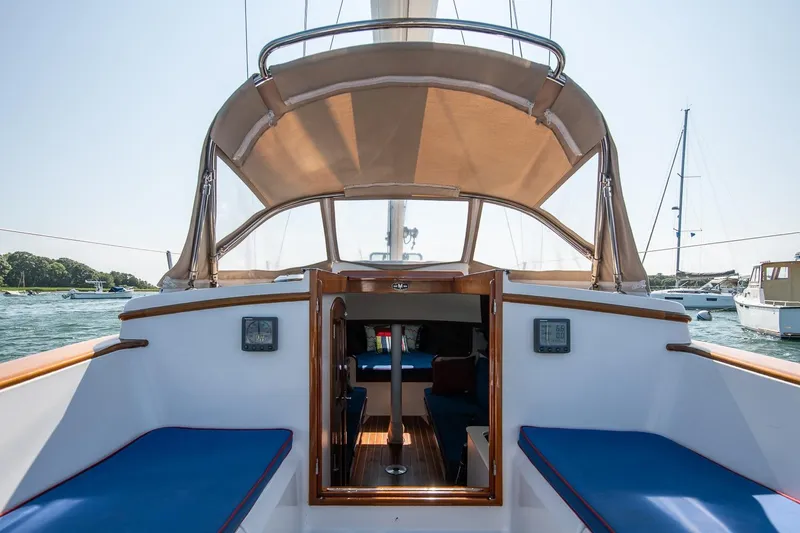 Slide: The Image of 2006 Morris M36 Daysailer interior with blue seating and canopy, docked in a marina. - 31