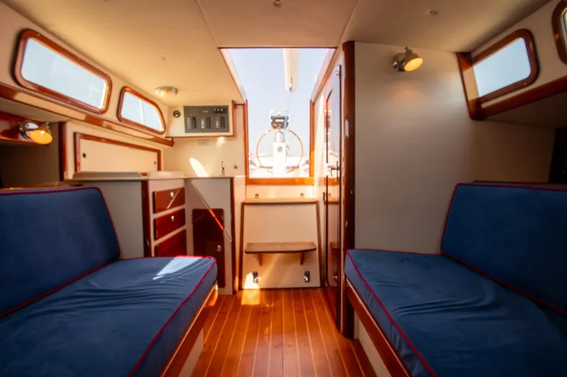 Slide: The Image of Interior of 2006 Morris M36 Daysailer with blue seating and wooden accents. - 34