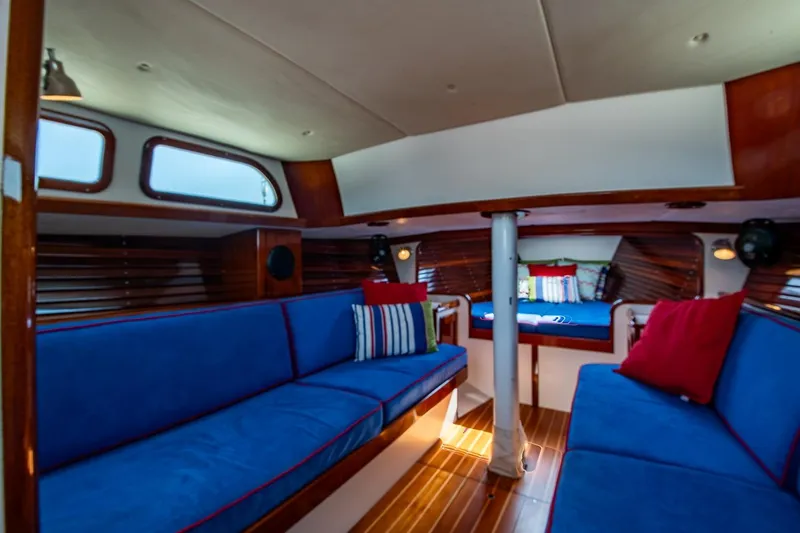 Slide: The Image of Interior of 2006 Morris M36 Daysailer with blue seating and wooden accents. - 36
