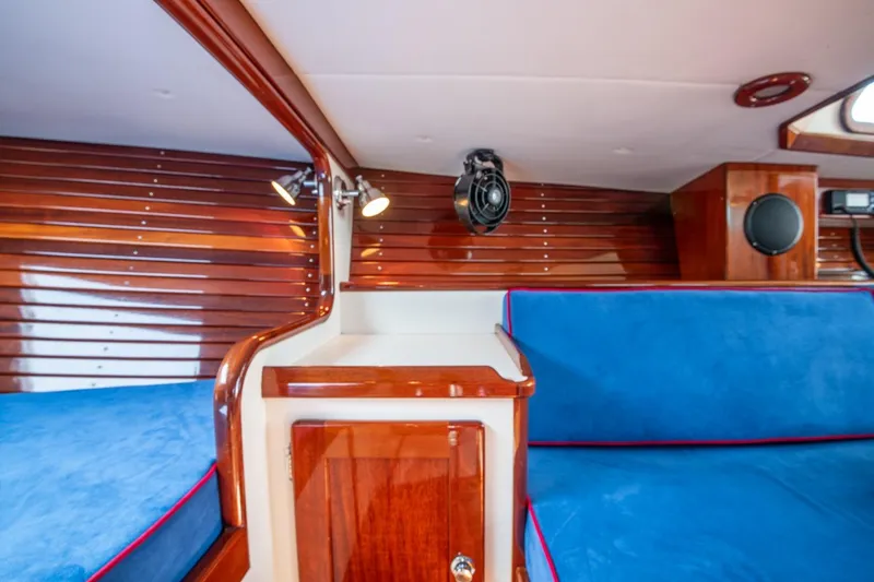 Slide: The Image of Interior of 2006 Morris M36 Daysailer with blue cushions and polished wood finish. - 37