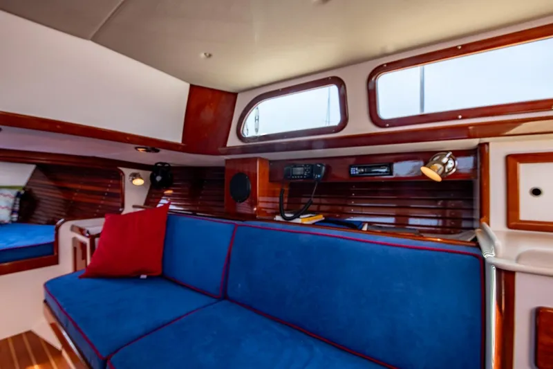 Slide: The Image of Interior of 2006 Morris M36 Daysailer with blue seating and wooden accents. - 38