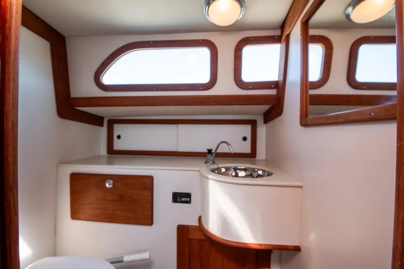 Slide: The Image of 2006 Morris M36 Daysailer interior with wooden accents and compact sink area. - 40