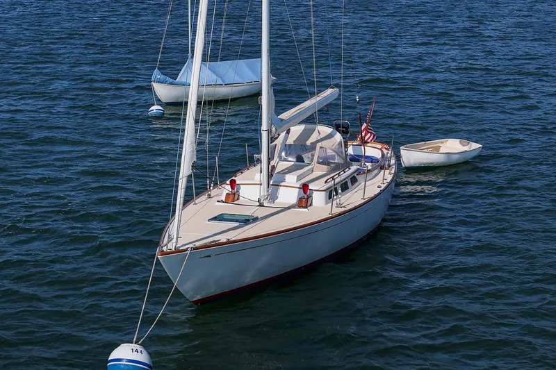 Slide: The Image of 2006 Morris M36 Daysailer on calm water with small boats nearby. - 7