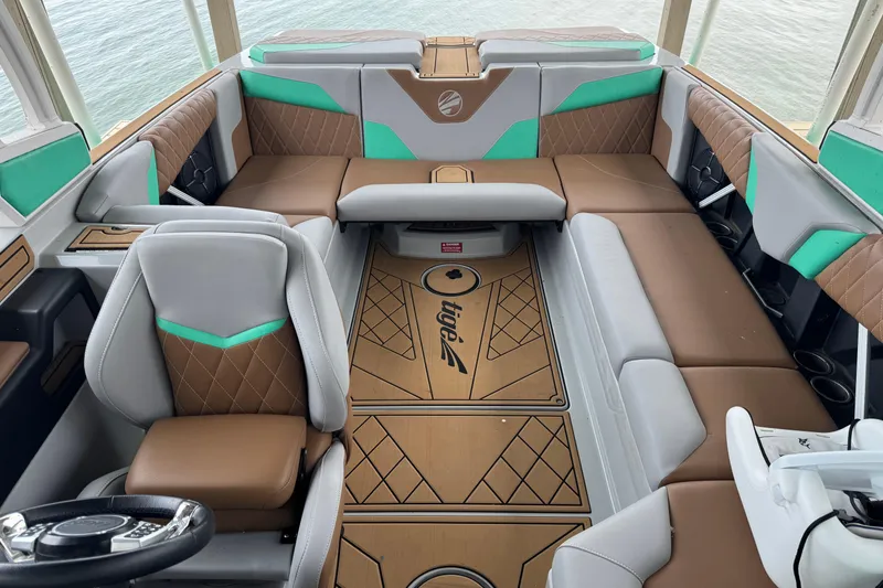 Slide: The Image of 2022 Tigé Z3 boat interior with brown and teal seating, elegant design. - 6