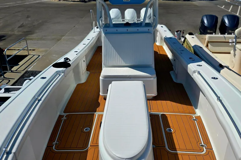 Slide: The Image of 2007 Yellowfin 36 boat with teak deck, white seating, and dual outboard motors. - 4