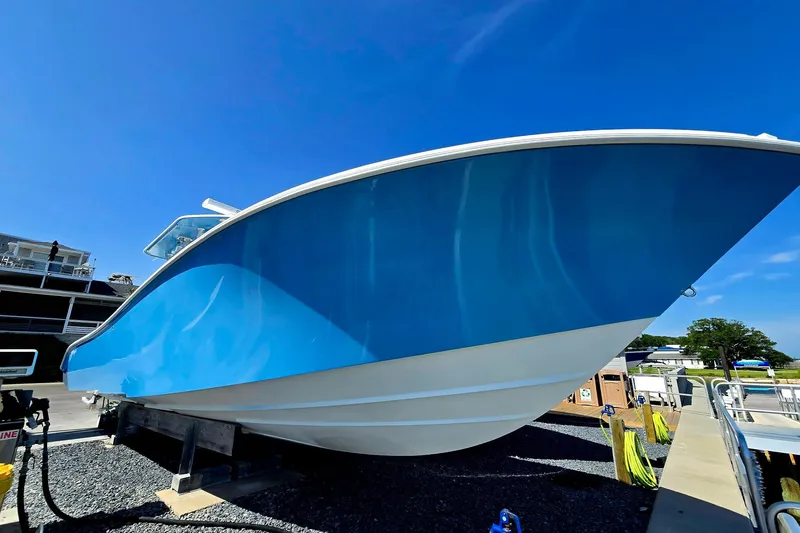 Slide: The Image of 2007 Yellowfin 36 boat with blue hull on display under clear sky. - 5