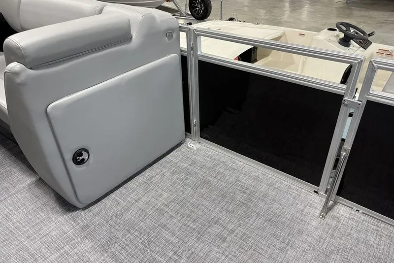 Slide: The Image of 2026 Sun Tracker SportFish 20 DLX storage compartments with open lids, showcasing interior space. - 15