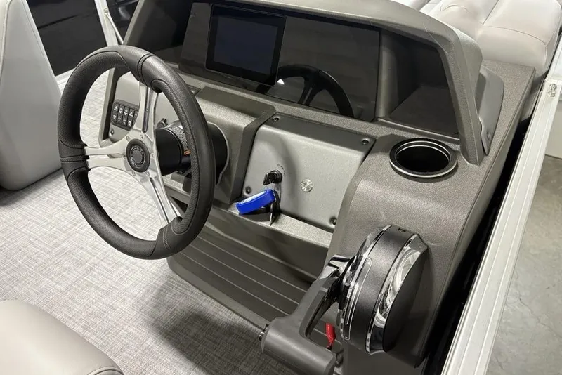 Slide: The Image of 2026 Sun Tracker SportFish 20 DLX boat seat with steering wheel, featuring gray upholstery. - 18